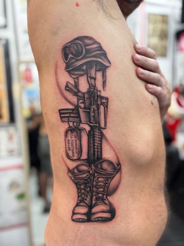 Black and grey realistic military tribute tattoo on torso
