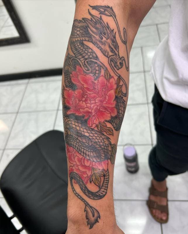Colorful Neo Japanese dragon and flower tattoo on forearm