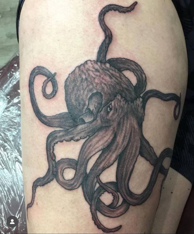 Black and grey realistic octopus tattoo on thigh